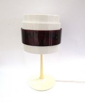 An Ikea Energi white and transluscent red banded table lamp designed by Magnus Eleback & Carl