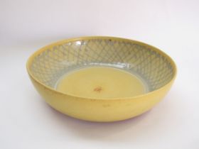 DAVID LLOYD-JONES (1928-1994) A large studio pottery bowl with yellow glaze and a blue crossed