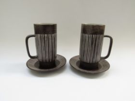 A pair of Einer Hellevoe BR keramik chocolate cups and saucers with vertical line detail. Cups
