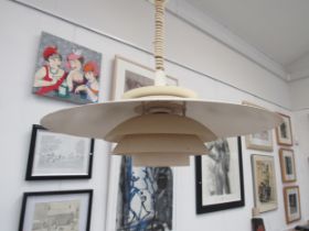 A Danish six tiered ceiling light in the Poulsen style in white finish with rise and fall fitting.