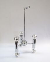 A Chromed metal ceiling light with three branches, each with a double ended light, chromed bulbs.