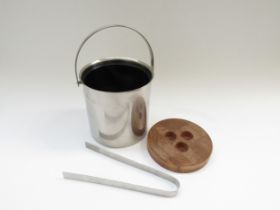 A Stelton Stainless steel 1960s ice bucket and tongs, wooden lid. Designed by Arne Jacobsen. 15cm