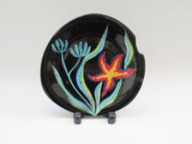 GABRIEL FAOURMAINTRAUX (1886 - 1984) 1960s asymmetrical black plate, hand painted and glazed.