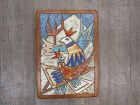 A large Scandinavian art pottery wall plaque with stylised bird design in wooden mount signed “