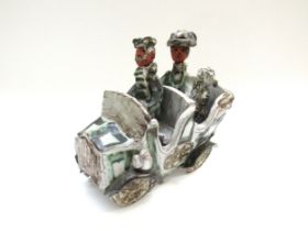 A Marie Whitby Seven Springs pottery 'figures in a car' , label to base, 19.5cm x 19cm x 13cm