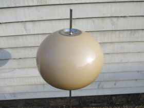 A chromed metal standard lamp with mushroom domed plastic shade, circular base