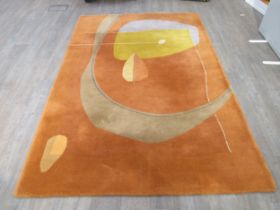 A French Toulemonde Bochart orange ground wool rug with leaf and line detail. (182cm x 270cm)