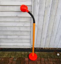 A 1970'S AB Fagerhults standard lamp in orange and yellow with single adjustable light