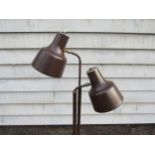 A Danish standard lamp in brown painted metal finish with twin adjustable spot lights