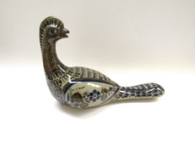 A studio ceramic figure of a Pheasant with painted detail, painted indistinct signature 40cm long