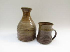 An Anthony Morris studio pottery carafe and tankard. Impressed seals. Tallest 23cm