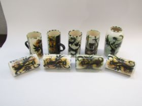 Eight Celtic pottery mugs of various designs, 13cm high and a Phoenix pattern vase, 16cm high
