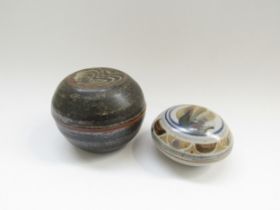 Two studio pottery lidded circular boxes with impressed potters seals. Largest 9.5 cm diameter x 7cm