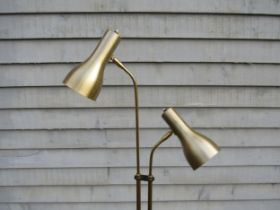 A Danish standard lamp in brassed metal finish with twin adjustable spot lights and on a circular