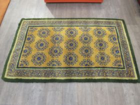 A rectangular "Readicut" rug in greens and ochre colours, c60's/70's, 190cm x 115cm