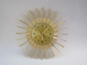 A Smiths Timecal starburst wall clock in white plastic. 38.5cm diameter