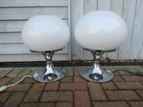 Two Harvey Guzzini globe table lamps designed by Luciano Buttura c1968, white globe shades on