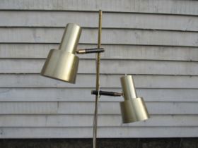 A Danish standard lamp in brassed metal finish with twin adjustable spot lights and on a metal