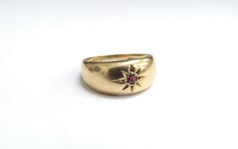 An 18ct gold gypsy ring, small garnet in star setting to centre. Size N, 2.2g