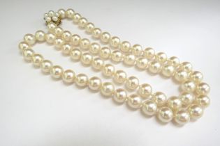 A single strand pearl necklace, 9mm pearls, gold clasp stamped 14k, 58cm long