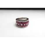 An 18t white gold ruby and diamond ring, 9.6ct ruby total, 0.71ct diamond total. Size L/M, 12.2g