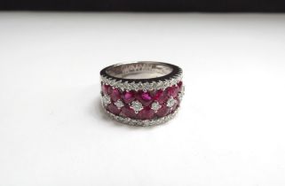 An 18t white gold ruby and diamond ring, 9.6ct ruby total, 0.71ct diamond total. Size L/M, 12.2g