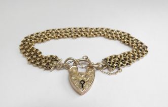A three row chain link bracelet with engraved padlock clasp, stamped 9ct, 17cm long, 13.1g