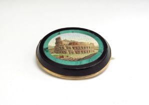 A Micro-Mosaic oval brooch depicting the Colosseum Rome, with a malachite border on black onyx,