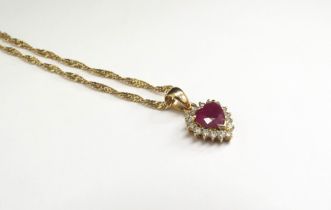 A heart shaped ruby and diamond cluster pendant stamped 18k hung on a gold chain, 44cm long, 5.5g