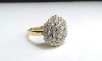 An 18ct gold diamond cluster ring, 16mm diameter. Size T/U, 9g