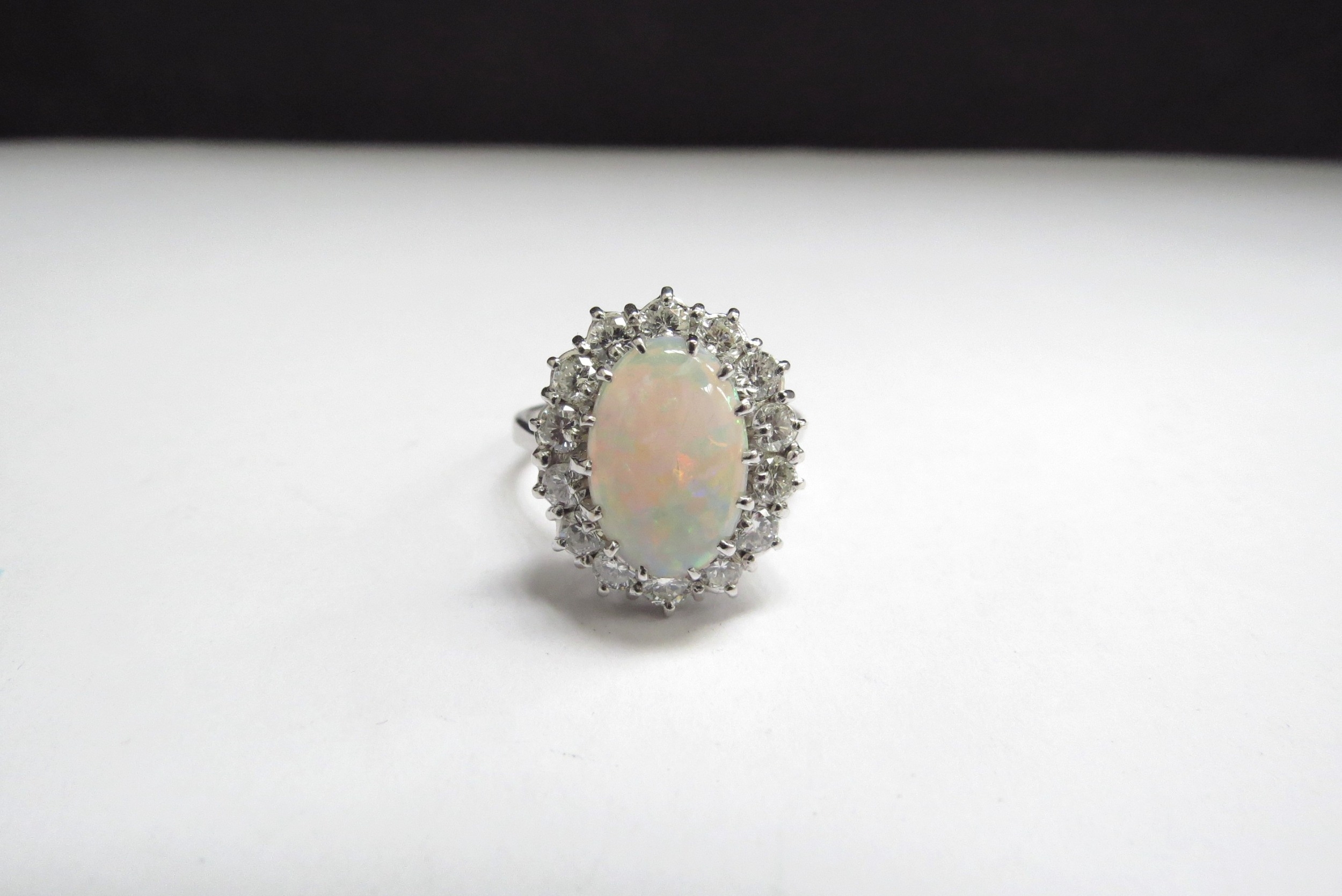 An 18ct white gold opal and diamond cluster ring the centre oval opal 14mm x 9mm framed by 14 - Image 3 of 3