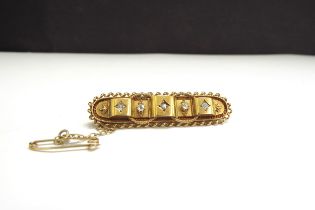 A 15ct gold brooch set with five diamonds, 4.5cm long, 5.6g