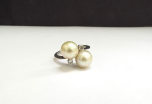 A white gold ring set with two large pearls and two diamonds. Size Q, 5.7g