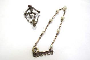 A pearl and gold bracelet, unmarked, 18cm long and a paste set brooch as a monkey with its baby on a