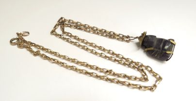 A 9ct gold chain, 54cm long, 11g, hung with a carved pendant of oriental man possibly blue jade in