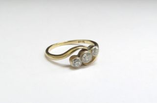 A three stone diamond crossover ring, 0.35ct total approx, stamped 18ct. Size N, 2.4g
