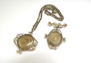 A 9ct gold scroll memorium pendant with a glass centre containing hair hung on a gold chain, 42cm