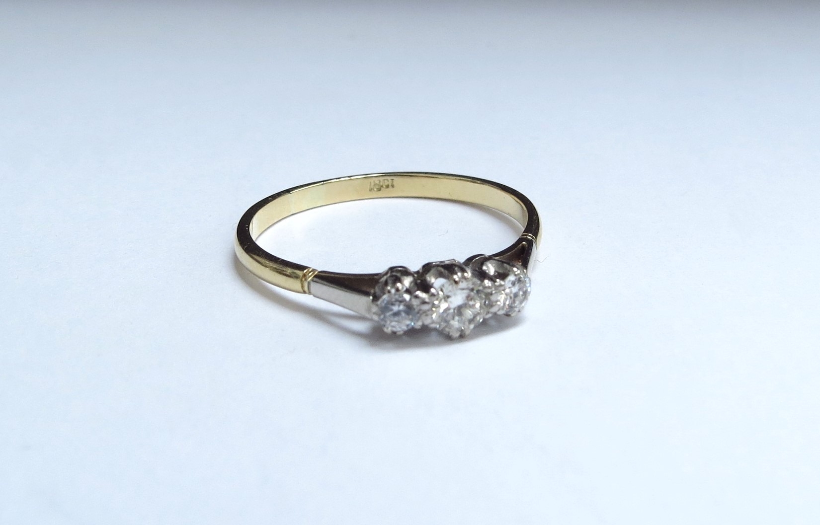 A three stone diamond ring, stamped 18ct. Size W/X, 2.6g - Image 4 of 5