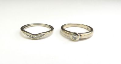 A 9ct white gold diamond ring, size M, 1.4g and a white gold diamond solitaire stamped 585, size L/