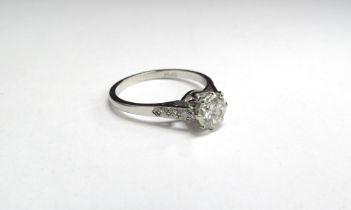 A single solitaire diamond ring with diamond set shoulders, stamped Plat 0.85ct approx. Size O, 3.7g