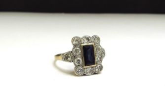 An 18ct/plat set Art Deco sapphire and diamond ring, the rectangular sapphire 7mm x 4mm framed by 10