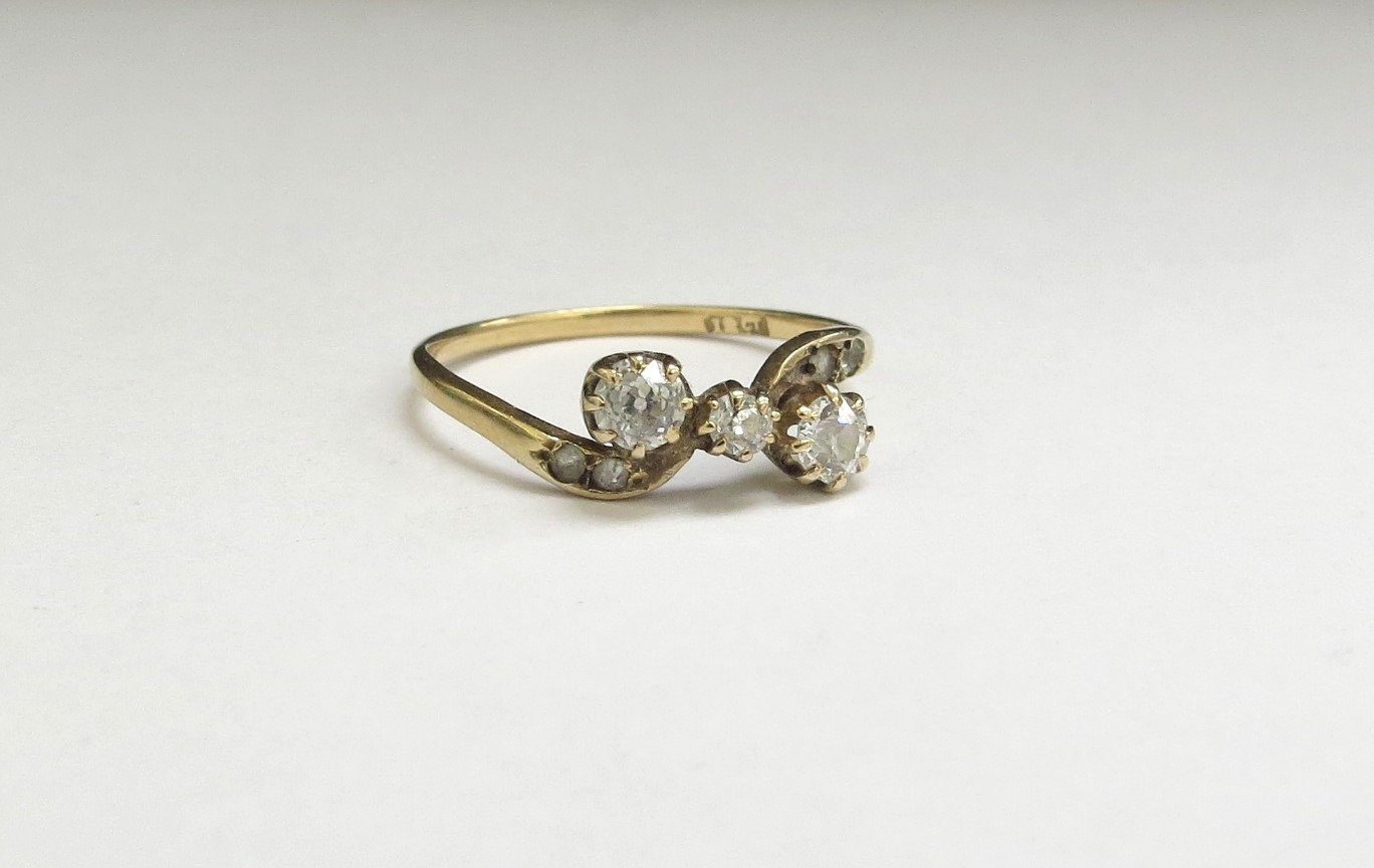 A three stone diamond crossover ring, 0.40ct approx total, stamped 18ct. Size O/P, 1.6g - Image 2 of 2