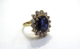 A sapphire and diamond cluster ring the central oval sapphire 11.5mm x 8.5mm, 3.47ct approx set in