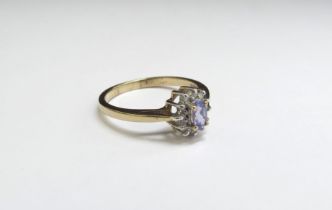 A 9ct gold tanzanite and diamond cluster ring. Size O, 2.1g