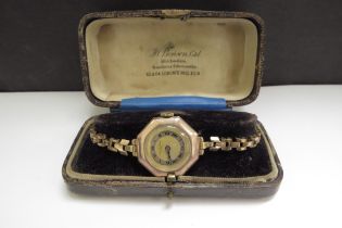A 9ct gold cased Bensons octagonal faced wristwatch, rolled gold strap, 22.7g total