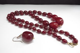 An amber bead necklace, 70cm long, 44.9g and one earring