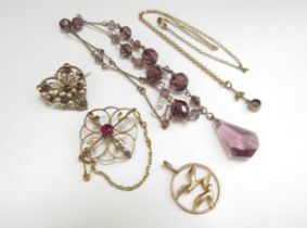 A 9ct gold necklace hung with an amethyst and seed pearl drop, a heart shaped brooch stamped 9ct,