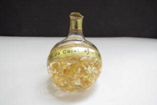 A hand blown glass bottle with 24ct gold flakes