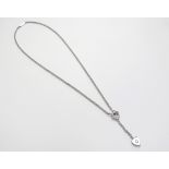 A Cartier 18k white gold heart Y shape swing drop single diamond necklace, marked NM2397750, 40cm