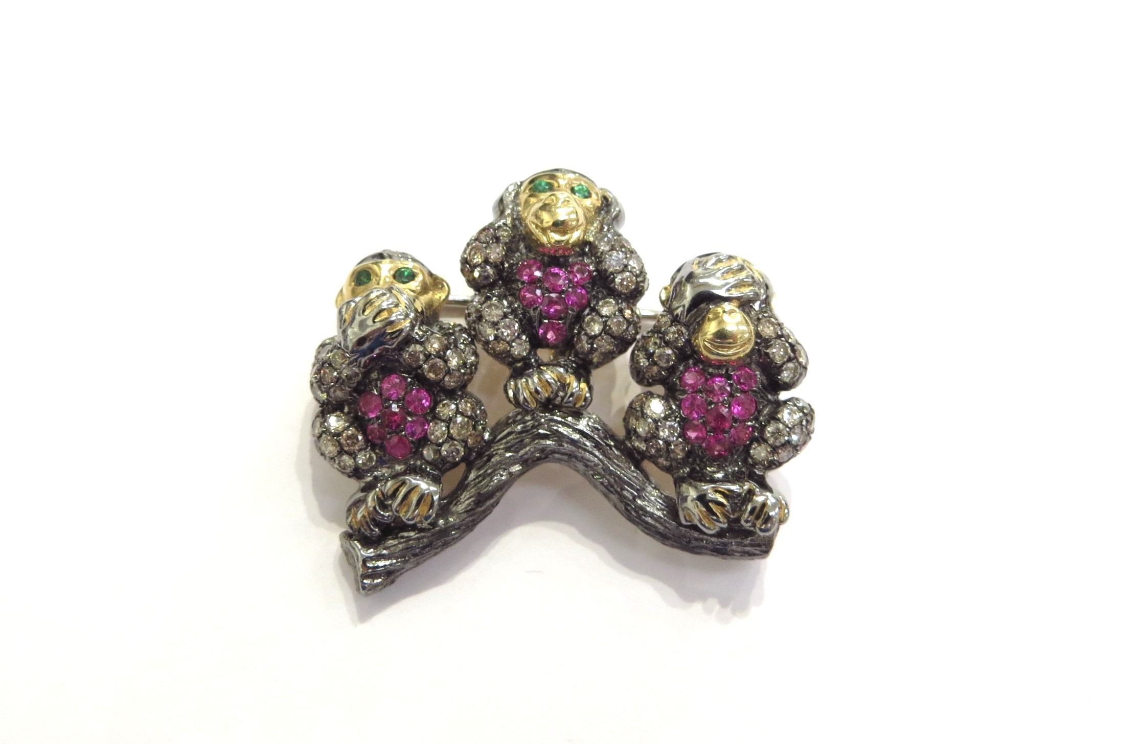 A gold brooch as three monkeys "See No Evil, Hear No Evil, Speak No Evil" encrusted with diamonds,